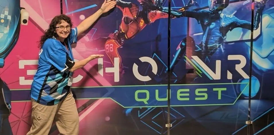 Sonya Haskins standing in front of Echo VR ad from Oculus Connect 2019